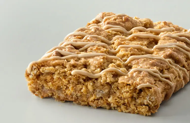 A singular unwrapped Nature Valley soft baked oatmeal square with a drizzle on top.