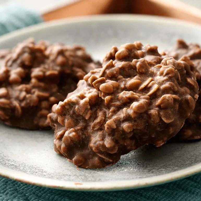 Clumps of no-bake cookies made with Nature Valley Oats & Dark Chocolate Protein Granola on a plate.