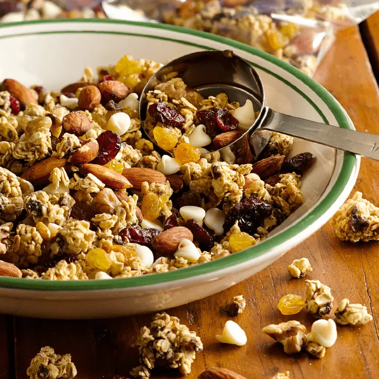 Trail mix made with Nature Valley Oats & Dark Chocolate Protein Granola, almonds, walnuts, cranberries, raisins, and vanilla chips.