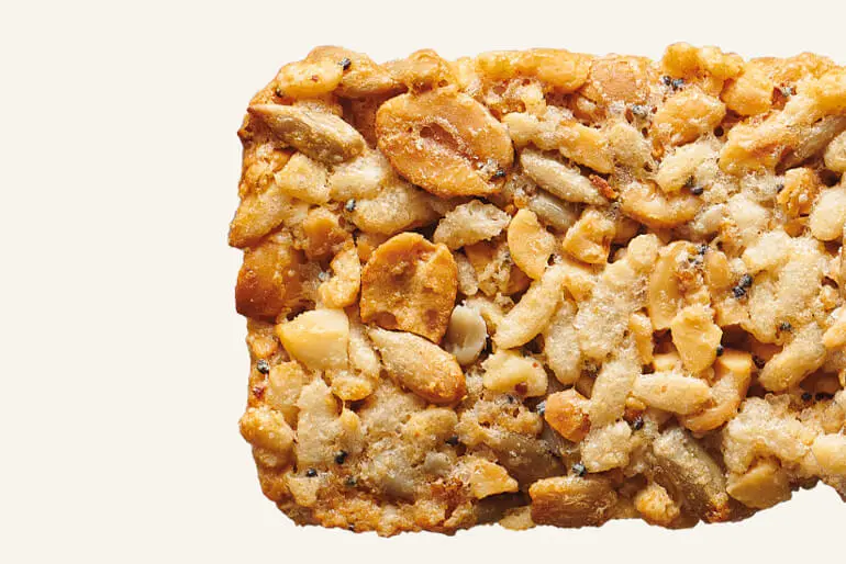 A close-up of a Nature Valley Savory Nut Crunch - Everything Bagel flavor bar.
