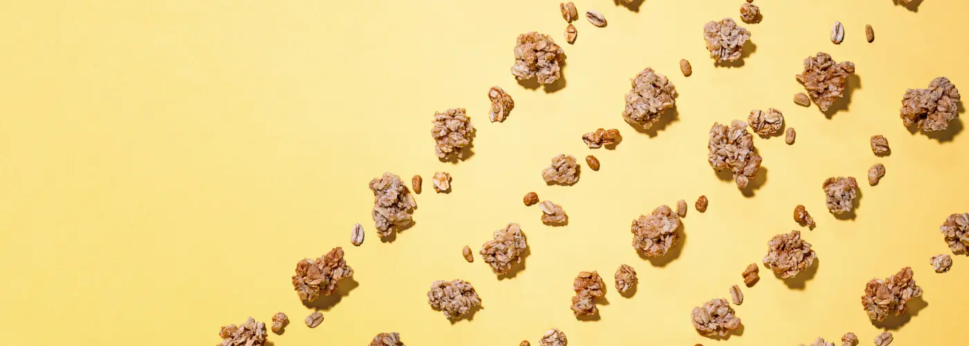 A yellow background with scattered granola