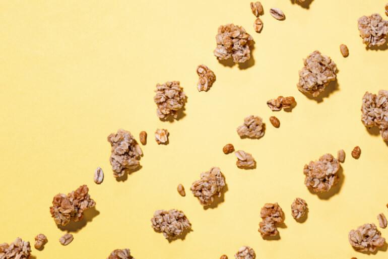 A yellow background with scattered granola