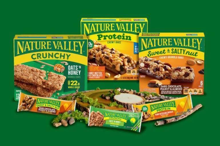 A collection of front facing Nature Valley. products, Crunchy Bars Oats & Honey, Protein Peanut Butter & Chocolate Chewy Bars and Sweet & Salty Dark Chocolate Peanut Almond Chewy Granola Bars on a green background